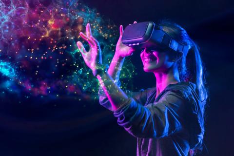 A person wearing a virtual reality headset, against a colorful background.
